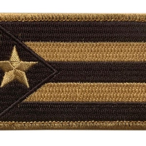 May include: A black and gold embroidered patch featuring the flag of Puerto Rico. The patch has a gold star and five gold stripes on a black background.