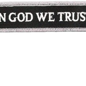 May include: Black embroidered patch with white stitching that reads "IN GOD WE TRUST".