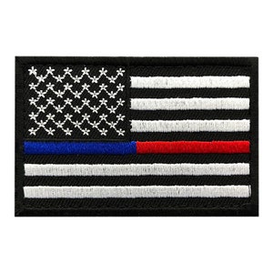May include: Black and white American flag patch with a thin blue line above a thin red line. The patch is embroidered and has a black border.