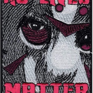 May include: Embroidered patch with a black and white image of a face with a red eye and the words "NO LIVES MATTER" in red.