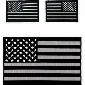 May include: Three black and silver American flag patches. The largest patch is approximately 4 inches by 6 inches. The smaller patches are approximately 2 inches by 3 inches.