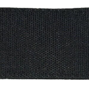 May include: Black hook and loop fastener patch. The patch is made of a textured fabric.