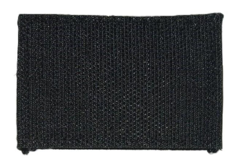 May include: Black hook and loop fastener patch. The patch is made of a textured fabric.