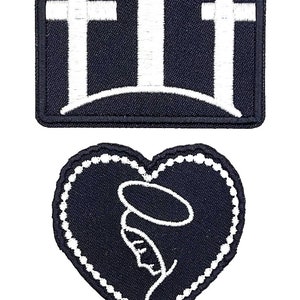 May include: Two embroidered patches, one with three white crosses on a black background and the other with a white outline of the Virgin Mary and a rosary on a black background.