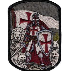 May include: A rectangular embroidered patch featuring a knight in silver armor with a red cross on the chest, holding a sword and a shield with a red cross. A lion and two wolves are positioned near the knight, with a flag and trees in the background.