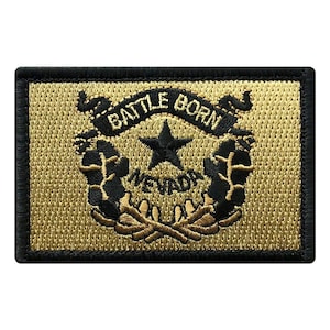 May include: A tan and black embroidered patch with the state seal of Nevada. The seal features a star, the words "Battle Born" and "Nevada", and a wreath of sagebrush.
