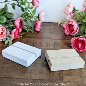 May include: Two card stands, one painted white and one unfinished, made of MDF wood.  Includes Your Choice of Card Stand: Painted White or Unfinished MDF.