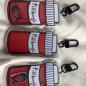 May include: A set of three ceramic mugs with a speckled, matte finish in cream, light grey, and dark grey. Each mug has a simple, minimalist design and a rounded handle.