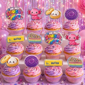 May include: A set of twelve cupcakes with pink and purple swirled frosting, each topped with a decorative cardstock topper featuring designs like a pink axolotl, a rainbow cake slice, a butter stick, a dumpling, a smiley face, and text reading In My Squishy Era.