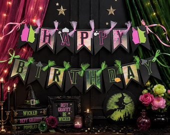 May include: A black banner set with the words "HAPPY BIRTHDAY" in pink and green letters, decorated with witch-themed cutouts and ribbons. The scene includes a witch hat, books, candles, and a framed sign that reads "Defy Gravity Be Wicked."