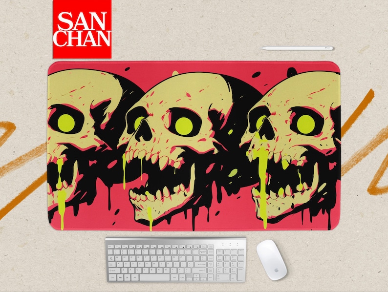 May include: A rectangular mousepad featuring three stylized skulls with yellow and black details, set against a red background. The skulls have green eyes and dripping green liquid. The mousepad has the text "SAN CHAN" in a red square.