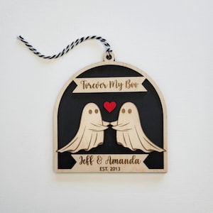 May include: Wooden ornament with two ghosts holding hands and a red heart. The ornament is black with the text "Forever My Boo" and "Jeff & Amanda EST. 2013".