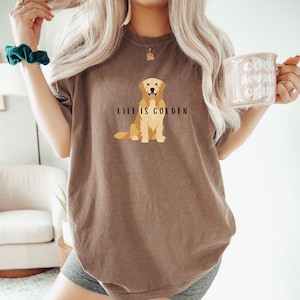 May include: A brown t-shirt with a golden retriever illustration and the text "Life is Golden".