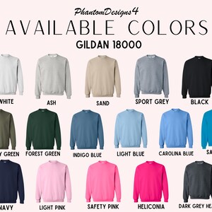 May include: A chart showing the available colors for Gildan 18000 sweatshirts. The colors include white, ash, sand, sport grey, black, military green, forest green, indigo blue, light blue, Carolina blue, sapphire, navy, light pink, safety pink, heliconia, and dark grey heather.