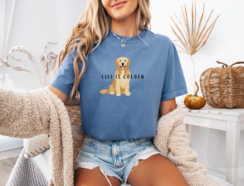 May include: A blue t-shirt with a golden retriever illustration and the text "Life is Golden".