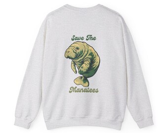 May include: A light grey sweatshirt with a green and brown manatee illustration and the text "Save The Manatees" printed on the back.