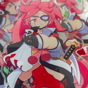 May include: A clear acrylic charm with a vibrant anime-style illustration of a female character. The character has pink hair, a black and white outfit, and a sword. The background shows similar charms, creating a layered effect.
