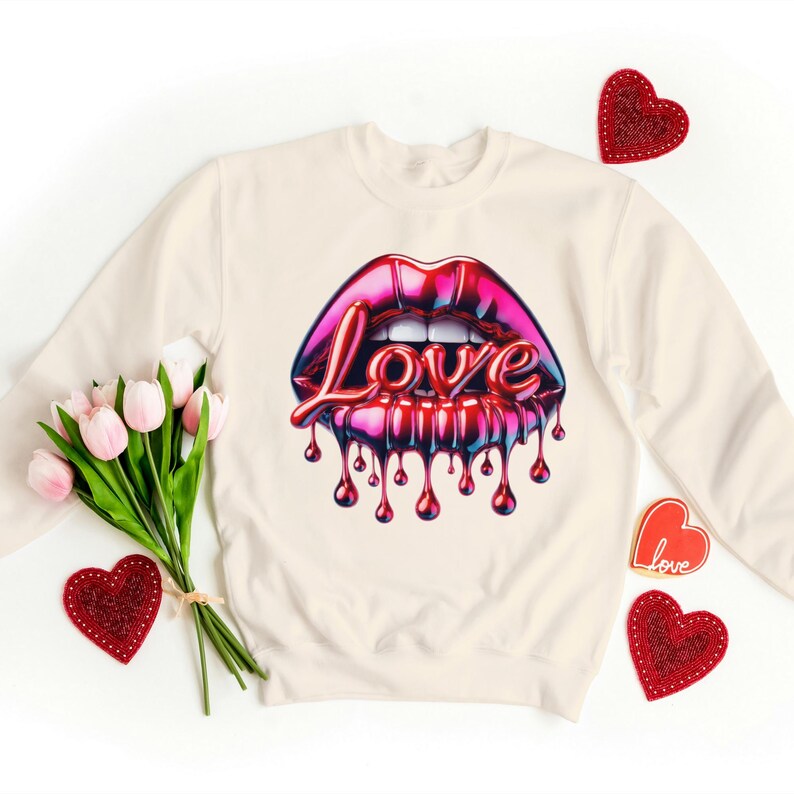 May include: A cream-colored sweatshirt with a graphic of red, pink, and blue glossy lips with the word "Love" dripping from the bottom.