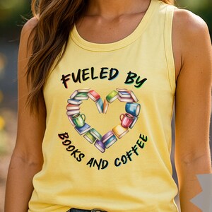 May include: A yellow tank top with the text "Fueled by Books and Coffee" in black and green. The graphic features a heart shape made of books and coffee cups. The tank top is a small size.