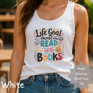 May include: White tank top with the text "Life Goal must READ all the BOOKS" in a colorful design. The graphic includes hearts, a book, and a cat reading. The tank top is sleeveless.