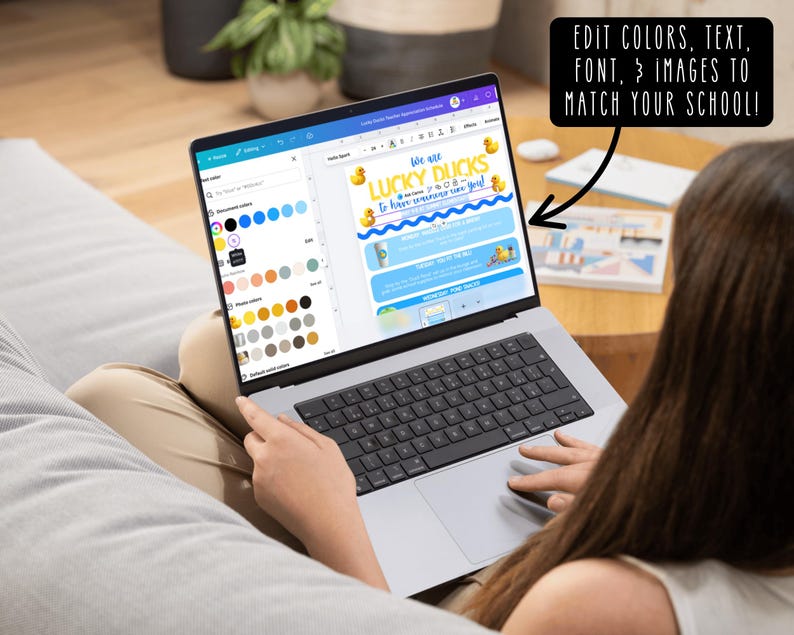 May include: A laptop displaying a design with the text "LUCKY DUCKS" and "EDIT COLORS, TEXT, FONT, & IMAGES TO MATCH YOUR SCHOOL!". The screen shows a design with yellow ducks and blue waves. The laptop is open on a person's lap.