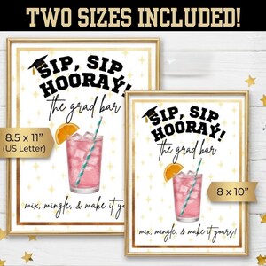 May include: Two framed prints with gold borders. The prints read "Sip, Sip Hooray! The grad bar" and feature a pink cocktail with an orange slice and a straw. One print is 8.5 x 11 inches, the other is 8 x 10 inches.