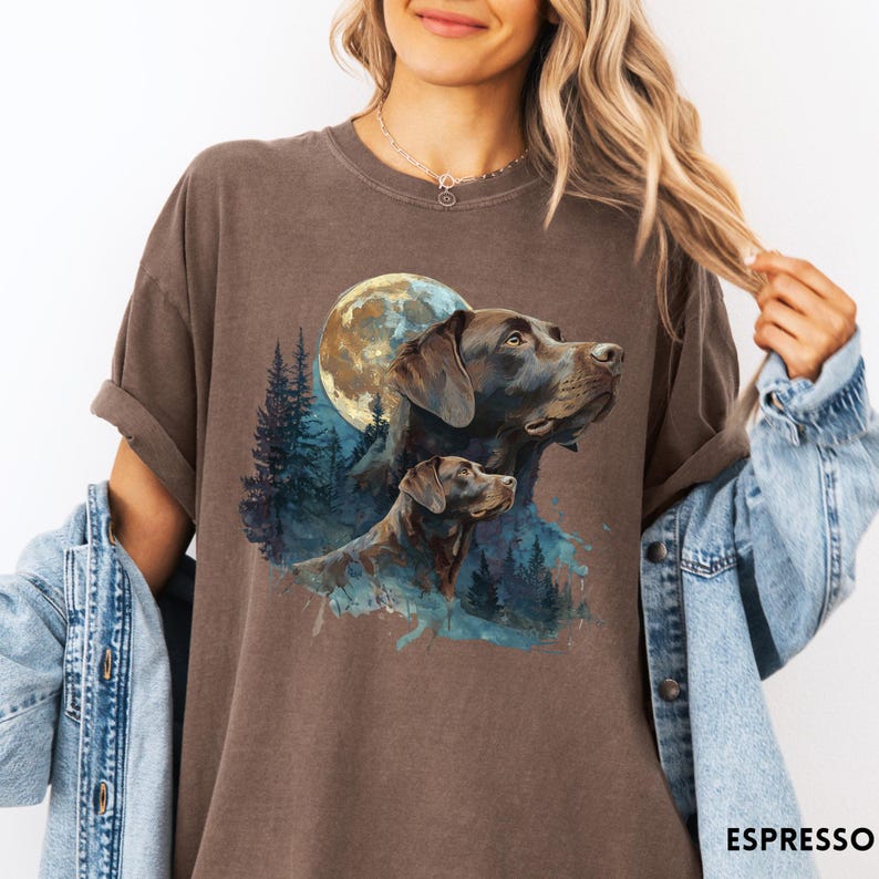 May include: Espresso-colored t-shirt featuring a watercolor illustration of two Labrador Retrievers with a full moon and forest backdrop. The shirt has a relaxed fit and rolled sleeves. The word "ESPRESSO" is printed at the bottom right.