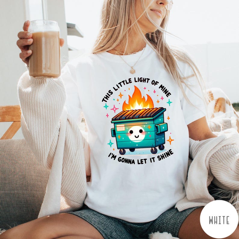 May include: White t-shirt with a graphic of a green dumpster on fire with the text "This little light of mine I'm gonna let it shine".