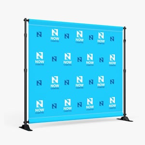 May include: A blue backdrop with a repeating pattern of the NOW Charities logo. The logo features two hands reaching towards each other, forming the letter N. The text "NOW CHARITIES" is below the logo.