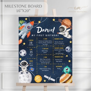 May include: A blue and yellow milestone board with a space theme for a baby's first birthday. The board includes the baby's name, Daniel, and details about their weight, height, favorite foods, songs, and toys. The board is decorated with stars, planets, and rockets.