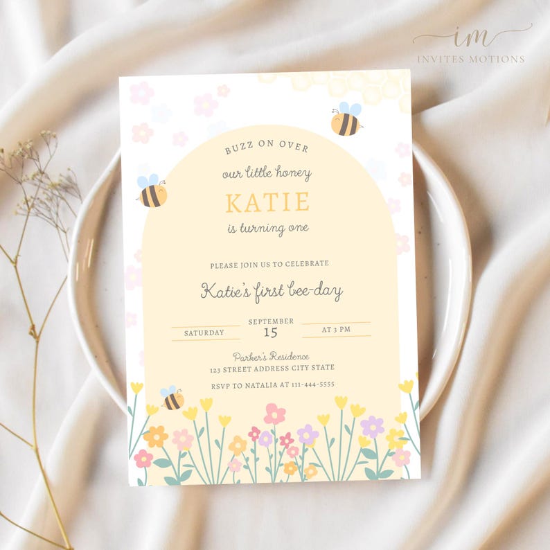 May include: A yellow and white bee-themed first birthday party invitation with a bee illustration and the text "Buzz on over our little honey Katie is turning one. Please join us to celebrate Katie's first bee-day. Saturday, September 15, at 3 PM. Parker's Residence, 123 Street Address City State. RSVP to Natalia at 111-444-5555."