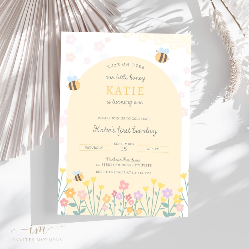 May include: A yellow and white bee-themed first birthday party invitation with a cartoon bee and flowers. The invitation says "Buzz on over our little honey Katie is turning one. Please join us to celebrate Katie's first bee-day. Saturday, September 15 at 5 PM. Parker's Residence 123 Street Address City State. RSVP to Natalia at 111-444-5555."