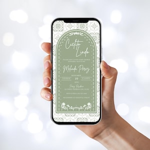 May include: A mobile phone screen showing a baby shower invitation. The invitation reads "Cielito Lindo" in script, with details for Melinda Perez's baby shower. The design incorporates a sage green and white floral border and decorative elements.