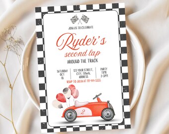 May include: A party invitation with a race car theme. The invitation features a red race car with balloons, a checkered border, and the text "Ryder's second lap around the track". Includes party details.