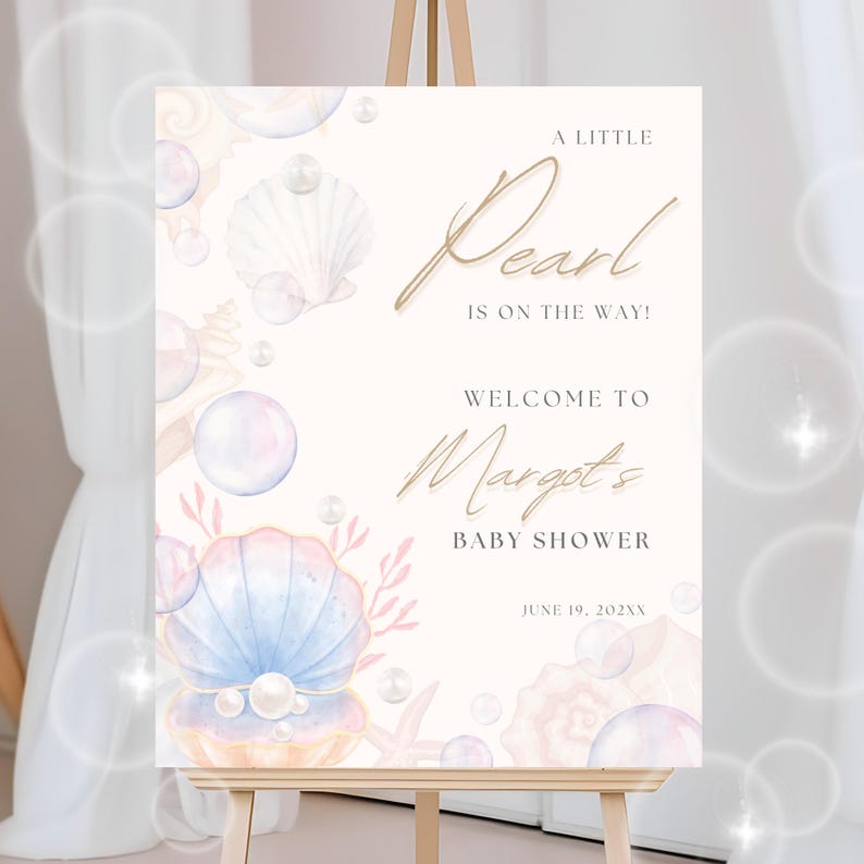 May include: A white welcome sign with a gold script font announcing a baby shower for Margot. The sign features a watercolor illustration of seashells, pearls, and bubbles. The text reads "A Little Pearl is on the way! Welcome to Margot's Baby Shower June 19, 202XX"