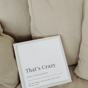 May include: A white framed print with the text "That's Crazy" and the definition "Thats Crazayl phrase" underneath. The text continues with "I'm no longer interested in the story. Wrap it up."