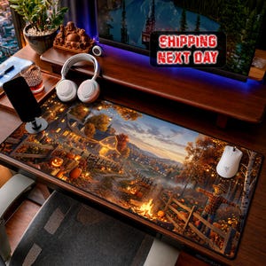 May include: A rectangular desk mat featuring a detailed autumn landscape illustration with a farmhouse, glowing jack-o'-lanterns, a scarecrow, and a campfire. The scene includes orange, yellow, and brown fall foliage under a twilight sky.