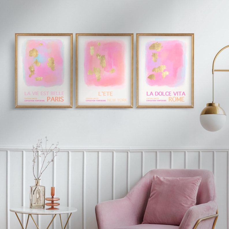 May include: Three framed pink and gold watercolor prints with the text "La vie est belle Paris", "L'ete New York", and "La dolce vita Rome".