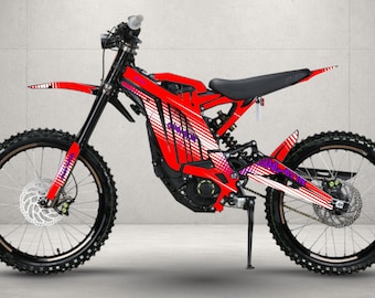 May include: A red electric dirt bike featuring a black seat, black wheels with disc brakes, and a frame adorned with white and purple graphic patterns. The bike includes a front fender, a kickstand, and a central motor housing in black.