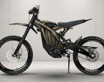 May include: An electric dirt bike featuring a black frame with tan and black striped patterned body panels. The motorcycle includes a black seat, front and rear disc brakes, knobby tires, a kickstand, and a rear suspension system.