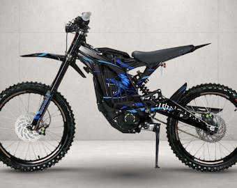 May include: A black electric dirt bike featuring blue graphic accents on the frame and front forks. The bike is equipped with knobby tires, disc brakes on both wheels, a black seat, and a kickstand. The frame displays a blue wolf head graphic.