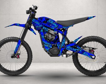 May include: A dirt bike featuring a vibrant blue graphic wrap with black accents. The frame and bodywork display the text Sticky Upgrade and Racing, along with a stylized animal head illustration. It has black wheels, tires, and a black seat.
