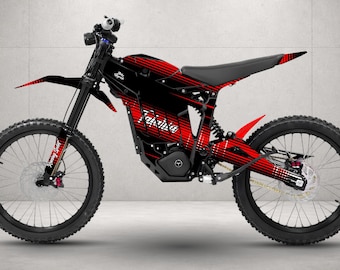 May include: An electric dirt bike featuring a black frame with red and white graphic stripes. The bike includes a black seat, black spoked wheels with knobby tires, disc brakes, and the text "Talaria" printed on the side of the battery housing.