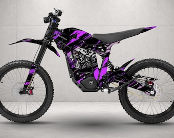 May include: An electric dirt bike featuring a black and purple graphic wrap with a stylized panther illustration on the frame. The bike includes black spoked wheels, a black seat, a front suspension fork, and a disc brake system on both wheels.