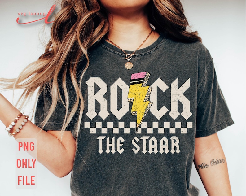 May include: A gray t-shirt with a graphic design of a yellow lightning bolt with pink accents and the text "ROCK THE STAR" in white letters.