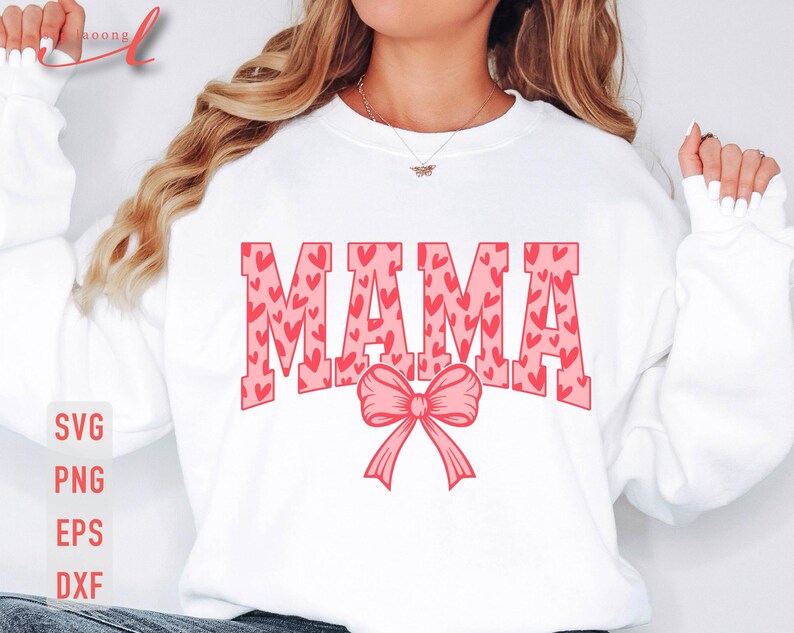 May include: White sweatshirt with the word "MAMA" in pink letters with a pink bow. The letters are filled with a pattern of pink hearts.