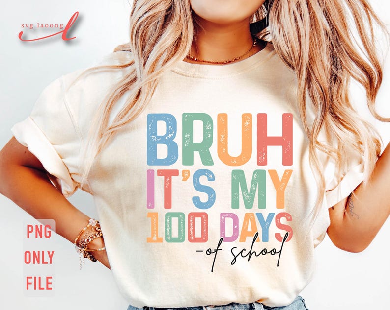 May include: A white t-shirt with the text "BRUH IT'S MY 100 DAYS -of school" in rainbow colours with a distressed look.