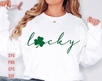 May include: White sweatshirt with the word "lucky" written in cursive with a green four-leaf clover graphic.