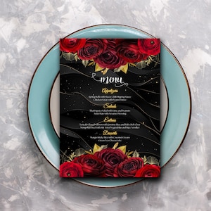 May include: A black menu with gold lettering and a red floral design. The menu lists starters, salads, main courses, and desserts. The menu items include Spring Rolls with Sweet Chili Dipping Sauce, Chicken Satay with Peanut Sauce, That Papaya Salad with Lime and Peanuts, Wan Slax with Sesame Dressing, Teriyaki Glazed Salmon with Jasmine Rice and Baby Bok Choy, Mango Beef with Stir Fried Vegetables and Rice Noodles, Mango Sticky Rice with Coconut Cream, and Green Tea Cheesecake.