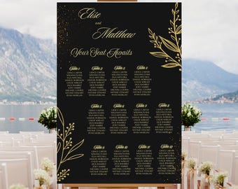 May include: A black wedding seating chart on an easel, featuring gold text and floral accents. The chart lists guest names under table numbers, with the names "Elise" and "Matthew" at the top.